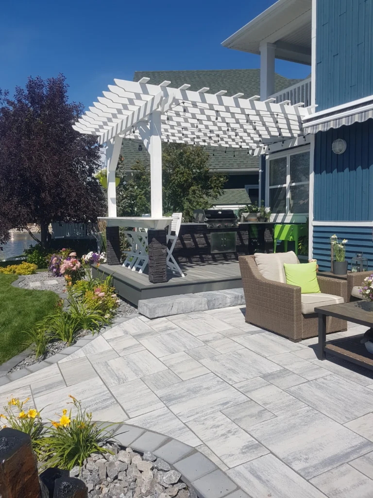Lower patio with upper patio containing kitchen and bar
